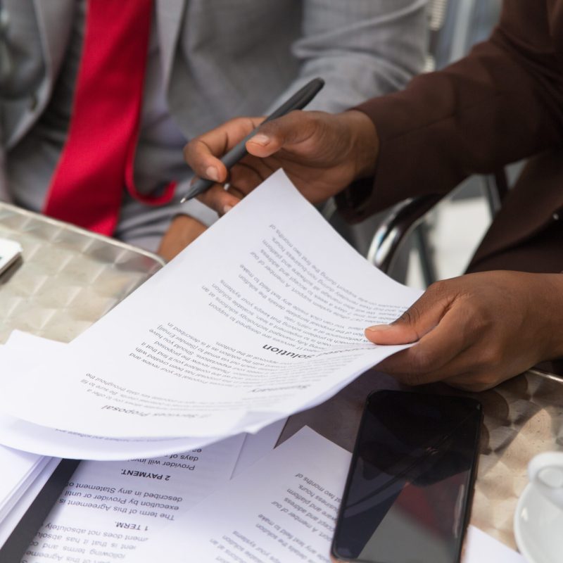 Businessman consulting legal expert Businessman consulting legal expert in coffee shop. Closeup of business man and woman sitting in cafe and reading documents. Paperwork concept